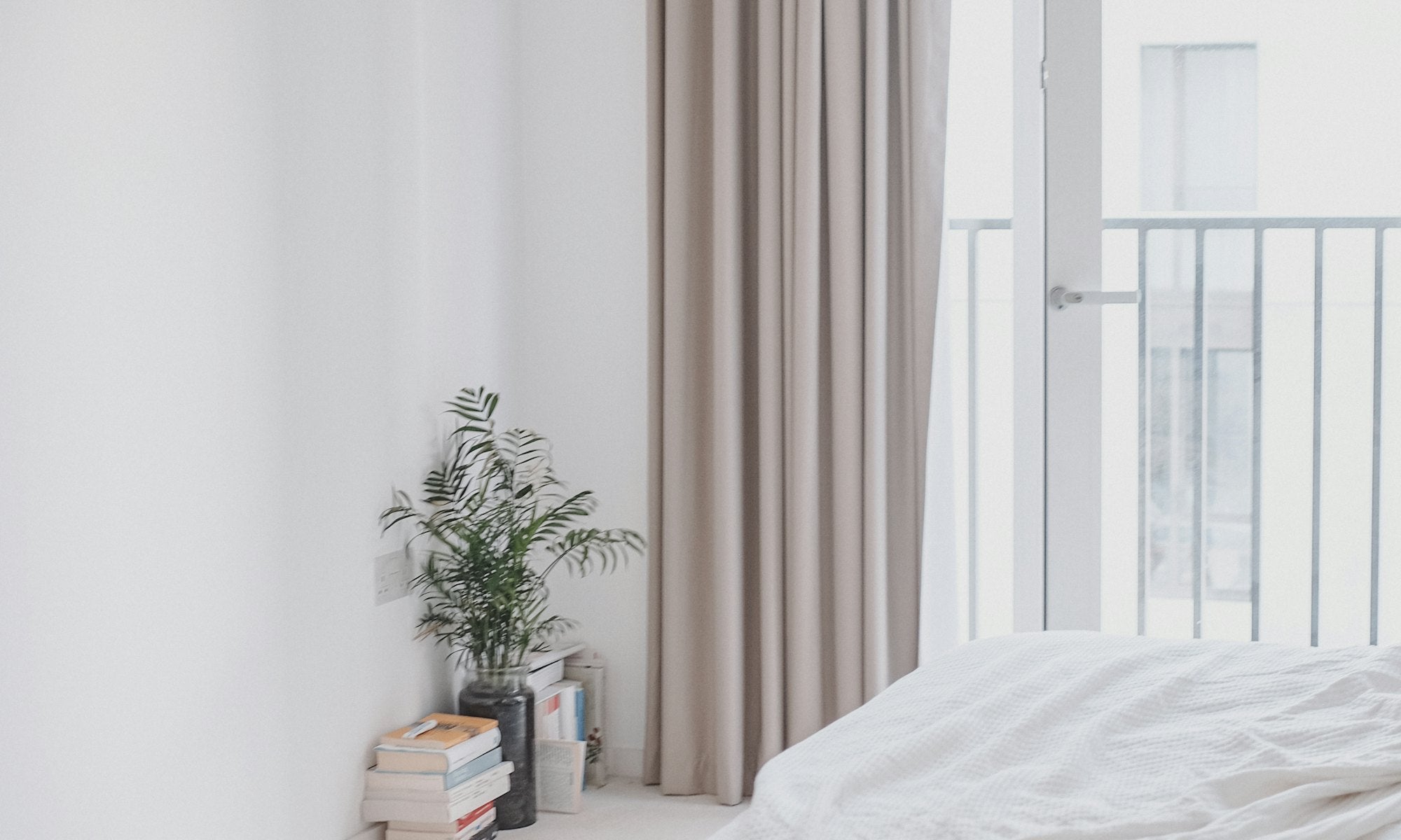 Bright bedroom with freshly made bed